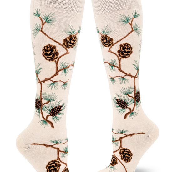 Cream knee-high socks with pinecone, branch and pine needle pattern.