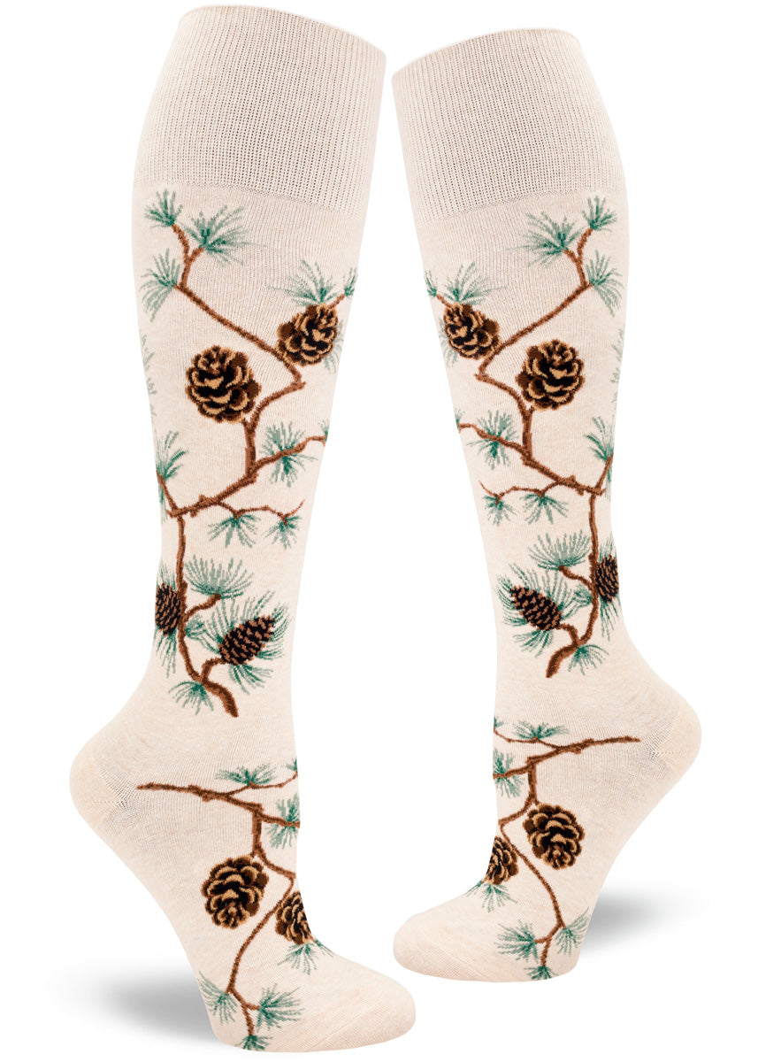 Cream knee-high socks with pinecone, branch and pine needle pattern.