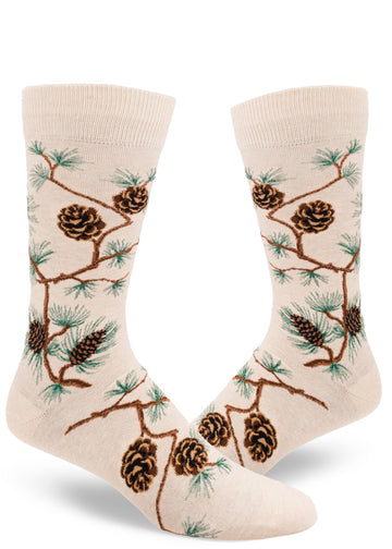 Cream crew socks for men with  allover pinecone and branch design and green pine needles.