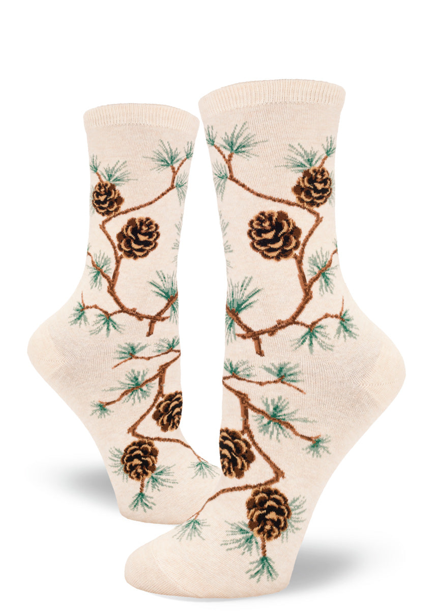 Cream crew socks for women with allover pinecone pattern and branches with clusters of pine needles.