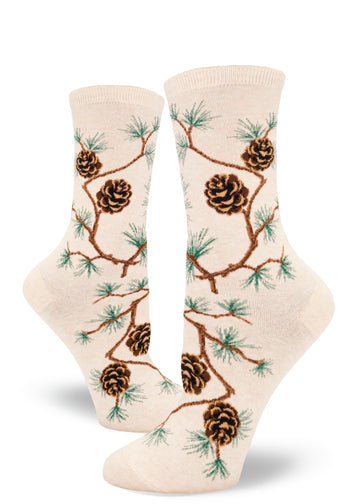 Cream crew socks for women with allover pinecone pattern and branches with clusters of pine needles.