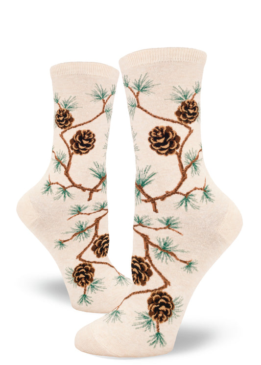 Cream crew socks for women with allover pinecone pattern and branches with clusters of pine needles.