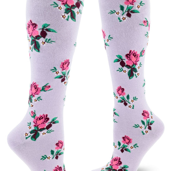 Light purple knee-high socks with pink roses and small white flowers in an allover repeating pattern.