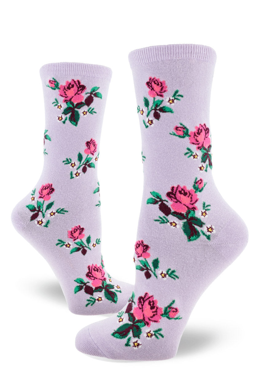 Light purple crew socks for women with allover repeating floral pattern of pink roses, small white flowers and greenery.