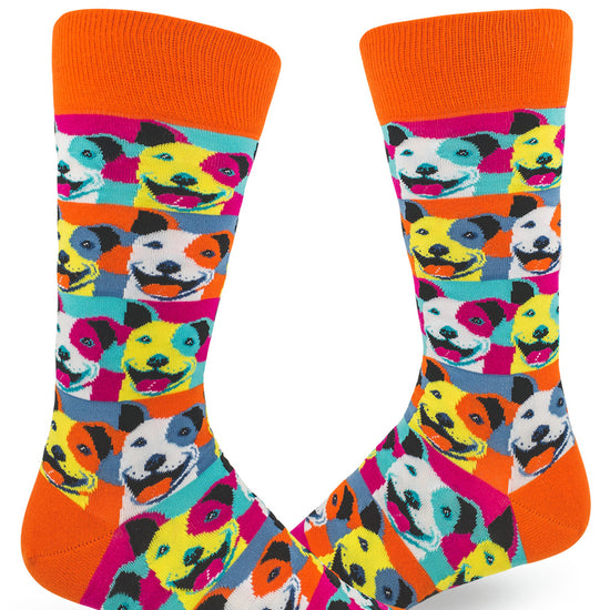 Colorful men's crew socks with allover repeating pattern of pit bull dogs in muticolored pop art style and orange cuffs and accents.