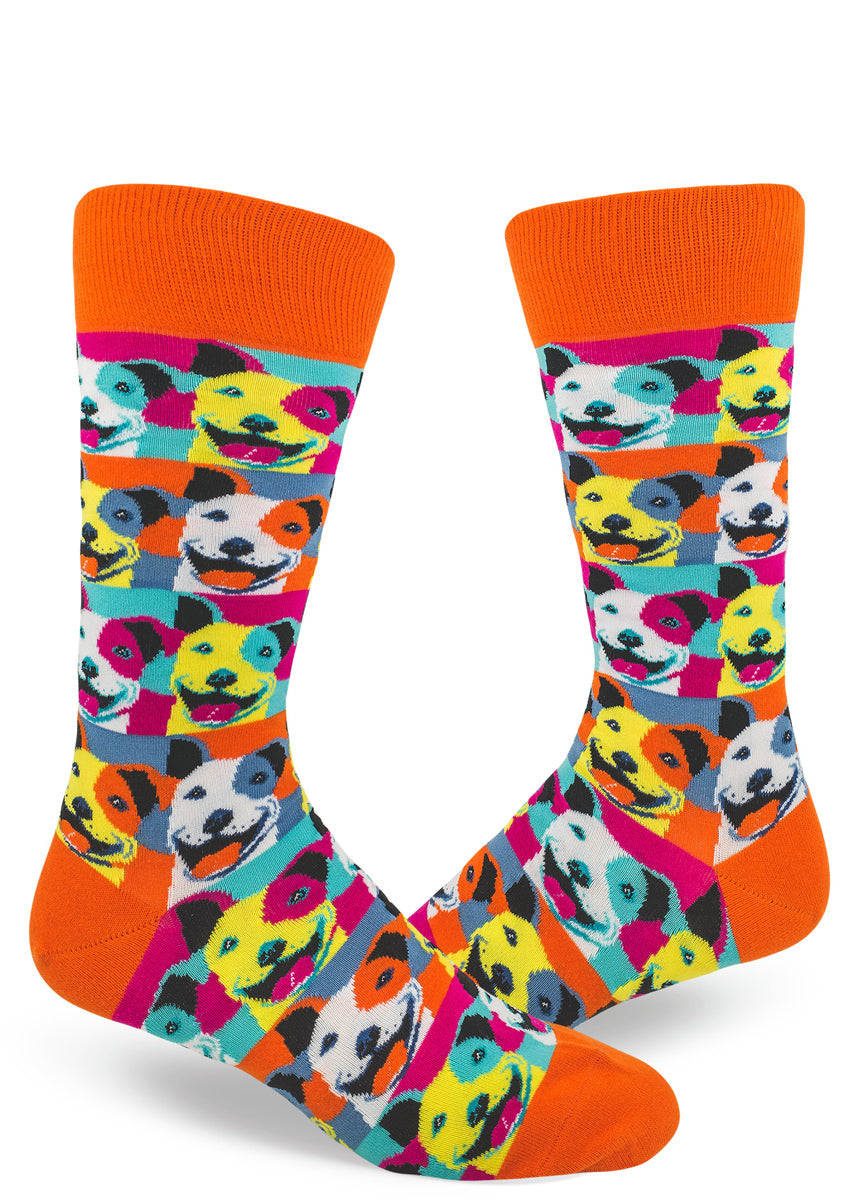 Colorful men's crew socks with allover repeating pattern of pit bull dogs in muticolored pop art style and orange cuffs and accents.