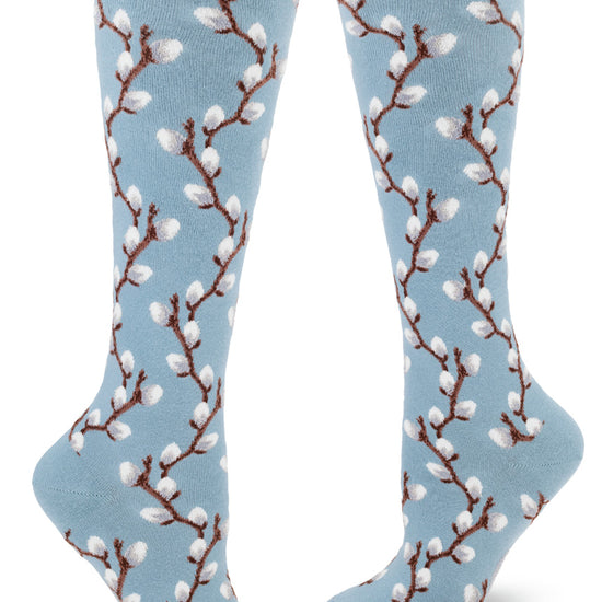 Knee socks with blue background and pussy willow design in raised textures yarn.