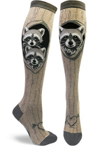Gray knee socks with tree bark pattern and a raccoon family looking out of its den with a heart with an arrow carved at the bottom.