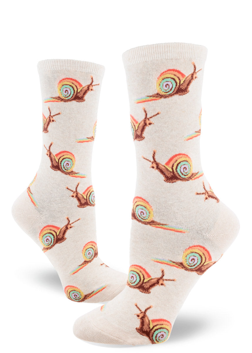 Cream crew socks for women with snails in rainbow shells leaving rainbow trails behind them in allover repeating pattern.
