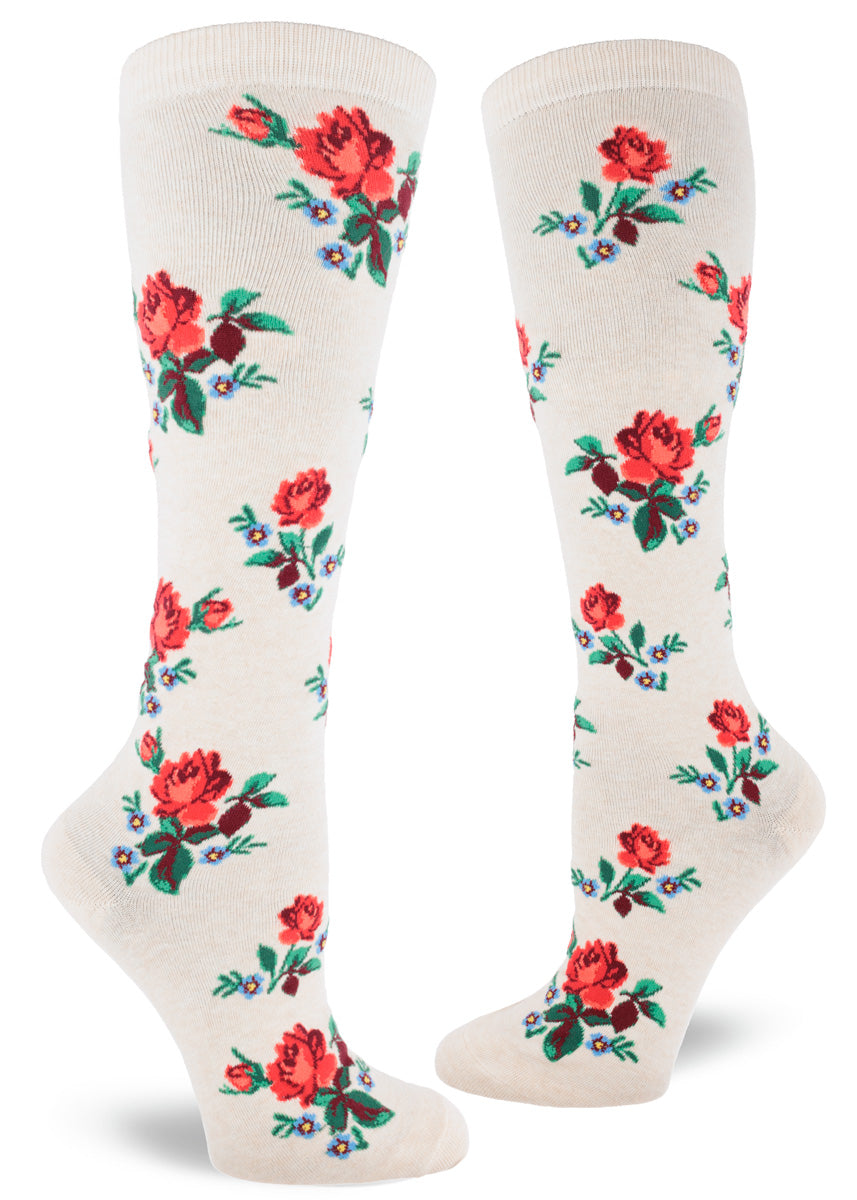 Cream knee-high socks with allover repeating floral pattern of red roses and blue forget-me-nots.