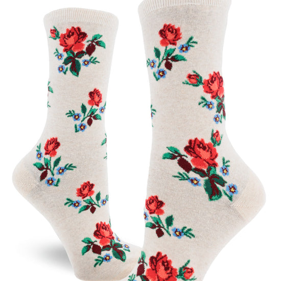 Cream crew socks for women with allover repeating pattern of red roses and forget-me-not flowers.