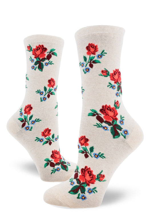Cream crew socks for women with allover repeating pattern of red roses and forget-me-not flowers.