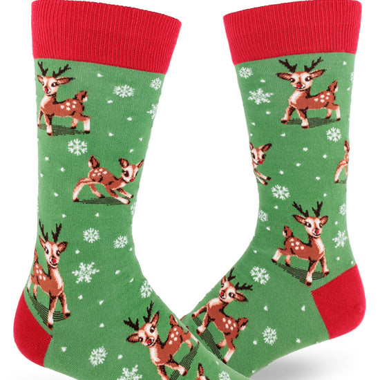 Green and red men's crew socks with Christmas reindeer playing between snowflakes.