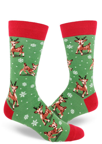 Green and red men's crew socks with Christmas reindeer playing between snowflakes.