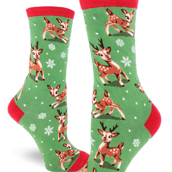 Green women's crew socks feature Christmas reindeer playing among snowflakes, with red cuffs and accents.