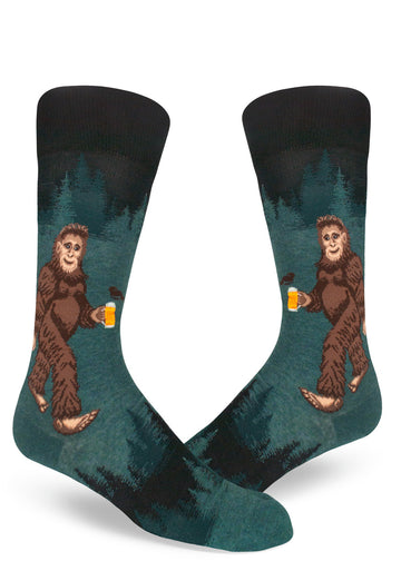 Men's crew socks in dark teal with a Sasquatch holding a beer in a forest.
