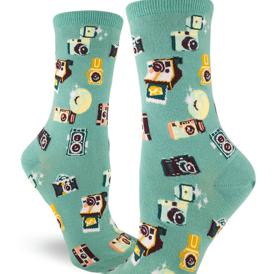 Light teal crew socks for women with allover repeating pattern of vintage cameras.