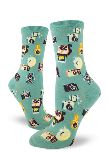 Light teal crew socks for women with allover repeating pattern of vintage cameras.
