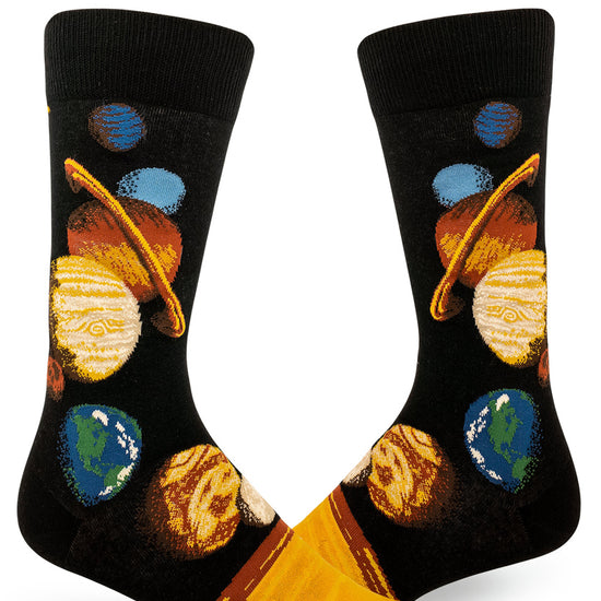 Black crew socks for men with a space design depicting all the planets of the solar system arranged in order in bright orange, yellow, green and blue.