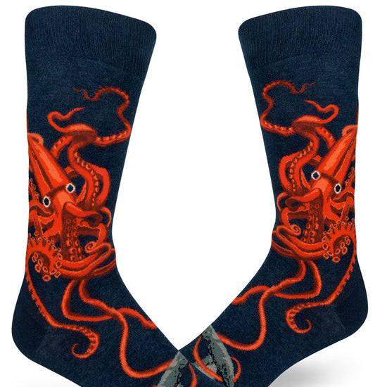 Navy blue men's crew socks featuring a bright orange giant squid design with tentacles twisting wildly.