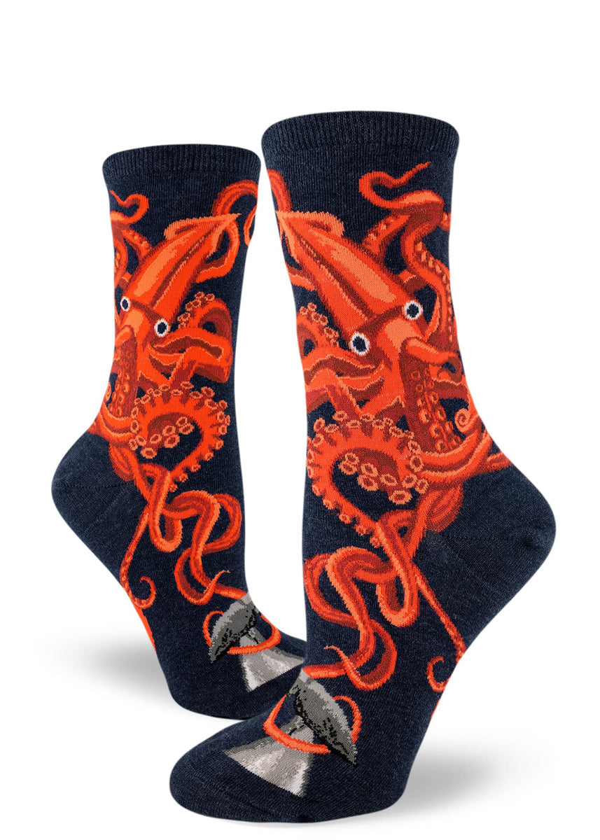 Navy blue women's crew socks with a bright orange giant squid with big eyes and twisting tentacles.
