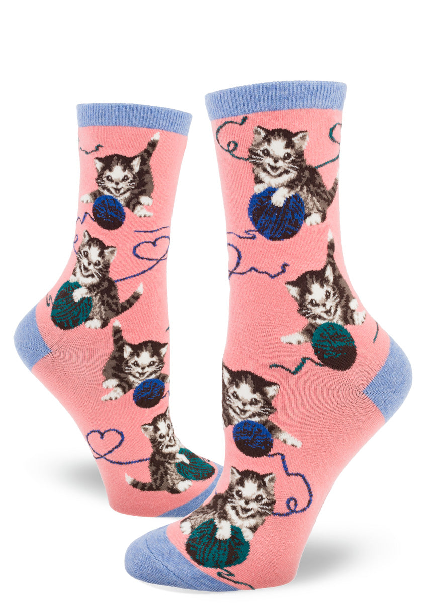 Bright pink women's crew socks with allover pattern of cute tabby kittens playing with balls of yarn.