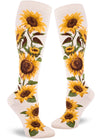 Cream colored knee-high socks featuring bold realistic sunflowers with yellow petals and brown centers and green foliage.
