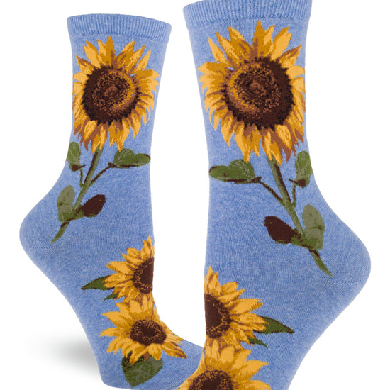 Light blue crew socks for women with large realistic sunflowers with yellow petals and green stems and leaves