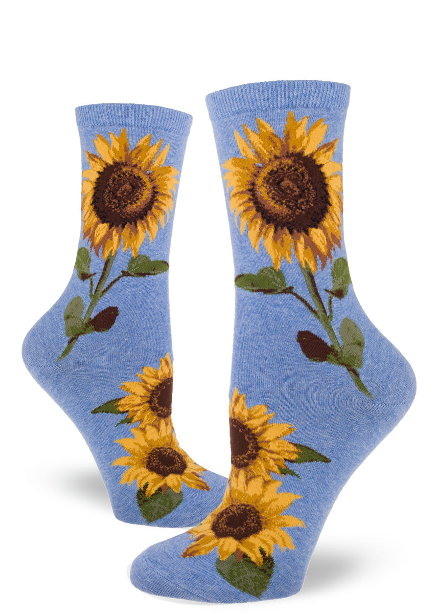 Light blue crew socks for women with large realistic sunflowers with yellow petals and green stems and leaves