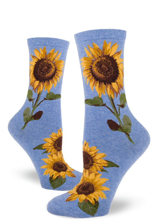 Light blue crew socks for women with large realistic sunflowers with yellow petals and green stems and leaves