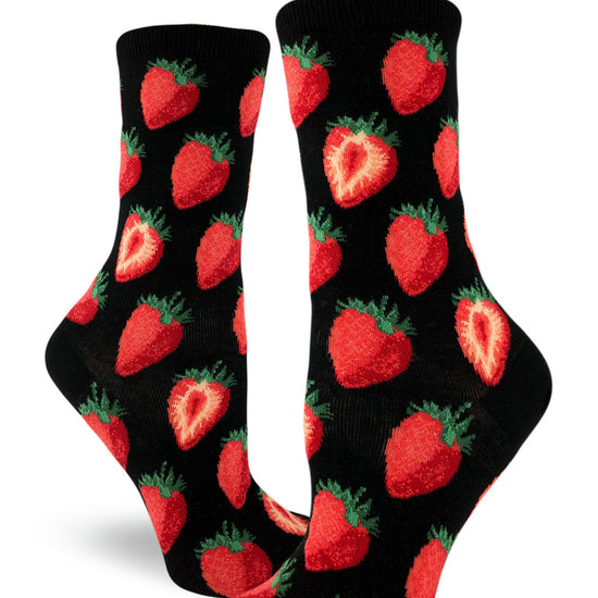 Women's black crew socks with repeating allover pattern of red strawberries whole and cut in half.