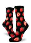 Women's black crew socks with repeating allover pattern of red strawberries whole and cut in half.