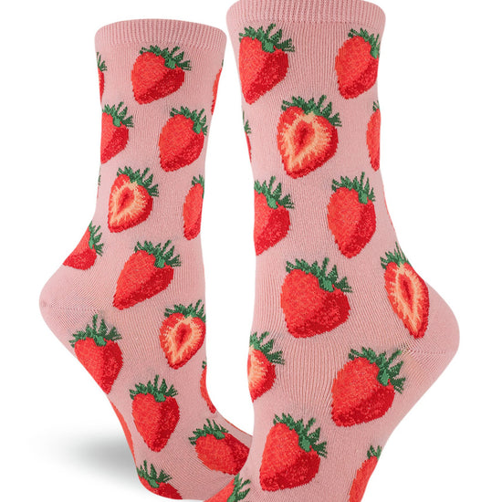 Light pink women's crew socks with repeating allover pattern of red strawberries, whole and cut in half.