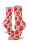 Light pink women's crew socks with repeating allover pattern of red strawberries, whole and cut in half.