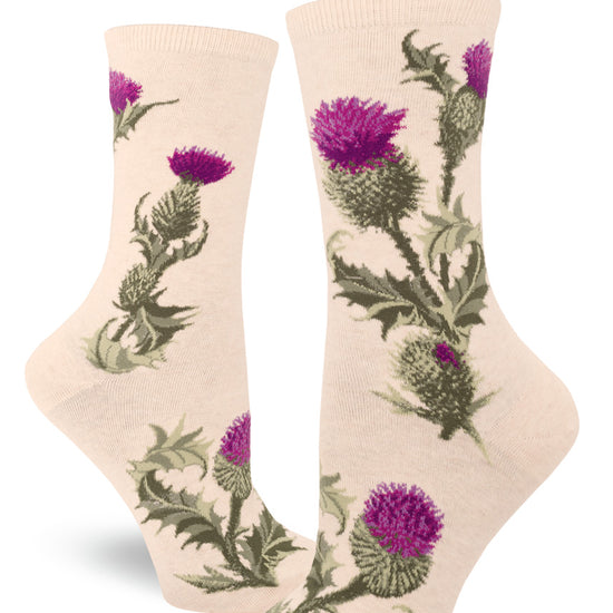 Cream-colored crew socks for women with thistle flower pattern featuring purple blossoms and prickly green buds, leaves and stems.
