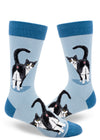 Light blue men's novelty crew socks with black and white tuxedo cats showing their butts with their tails raised and faces turned backward.
