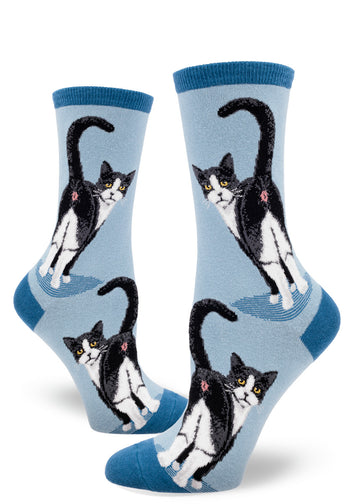 Light blue women's crew socks with black and white tuxedo cats showing their butts with their faces turned back.