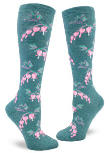 Knee-high socks with a teal background featuring a repeating pattern of pink bleeding heart flowers.